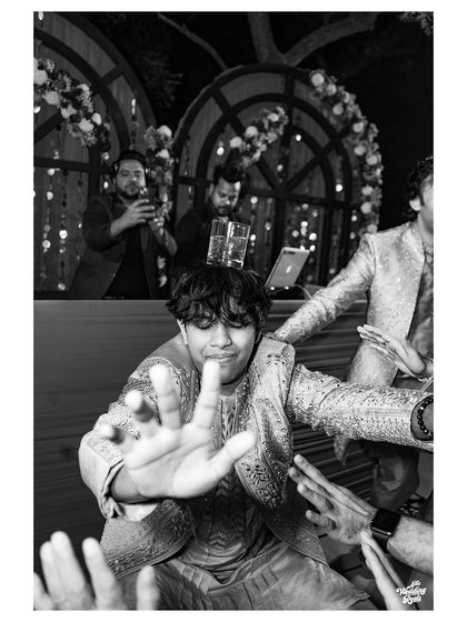 A fun, candid black and white shot from the dance floor, capturing the energy of the party from a unique perspective.