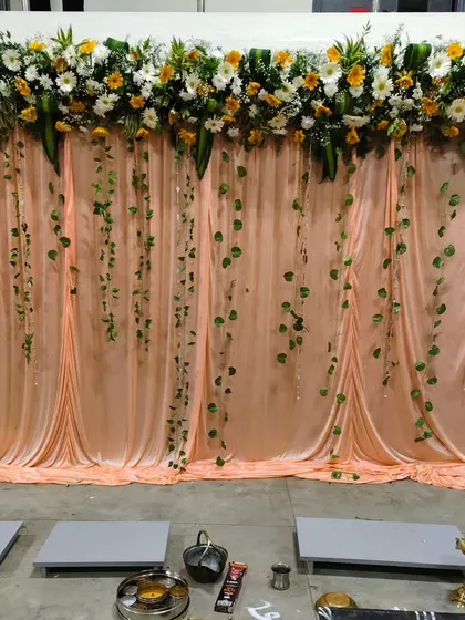 To celebrate a company milestone, I designed this elegant backdrop using soft fabric drapes, a fresh floral runner, and hanging green vines. It provides a perfect setting for photos and formal ceremonies.
