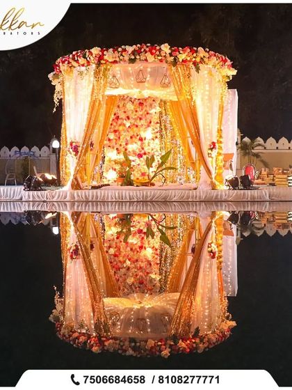 A breathtaking poolside mandap, beautifully reflected in the water. The combination of vibrant flowers and the serene water element creates a truly magical and picturesque setting.