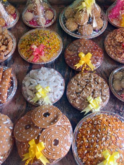 An assortment of traditional South Indian sweets and savories, beautifully packed and ready for a function. I can arrange a wide variety of items based on your preference.