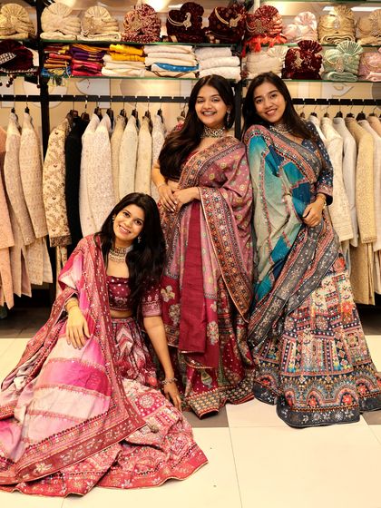 This photo shows three friends in different lehengas from my collection. It demonstrates the range of styles I offer, from bold maroons to vibrant multi-color prints.