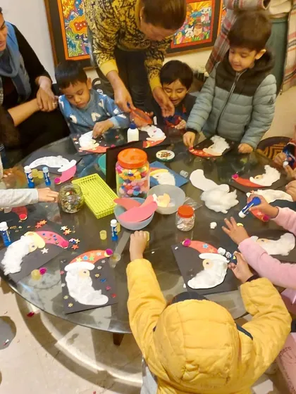 Our toddler group had a wonderful time making Santa cards. The table was full of cotton-ball beards, red hats, and lots of glittery fun.