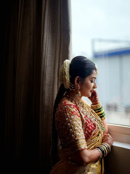 A quiet moment of reflection for the bride. The rich red and gold of her custom outfit looks absolutely stunning.