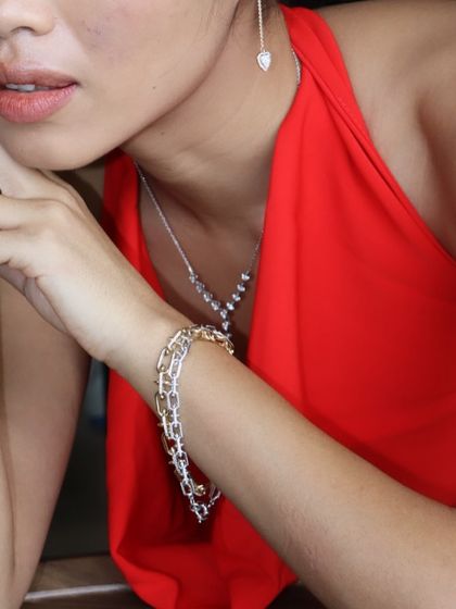A closer look at our diamond necklace set, featuring a Y-shaped pendant, matching drop earrings, and a mixed-metal bracelet stack for a complete bridal look.