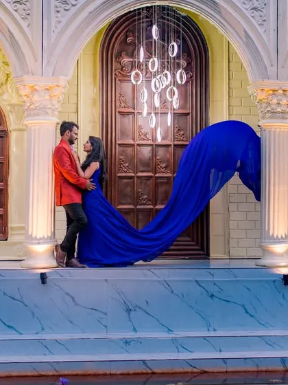 We create drama and elegance by combining grand architecture with bold fashion choices. The flowing royal blue gown against the ornate doorway and modern chandeliers makes for a powerful and timeless pre-wedding photograph.