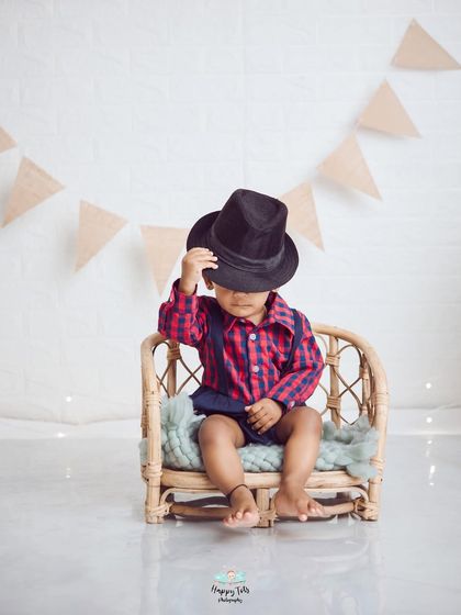 Tipping his hat with style. We love it when kids have fun with props and show off their playful side during a shoot.