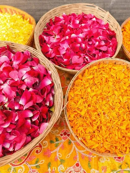 Baskets filled with colorful rose and marigold petals, ready for the celebration.