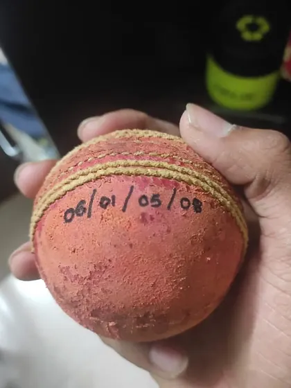 The match ball from Tanmay Jagtap's 5-wicket haul, with his figures written on it. A prized possession for any bowler.