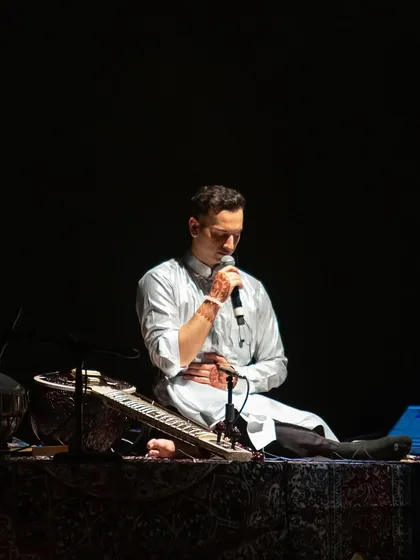 Leading a guided meditation during a show. My hand is on my chest to encourage the audience to connect with their breath and their heart space.
