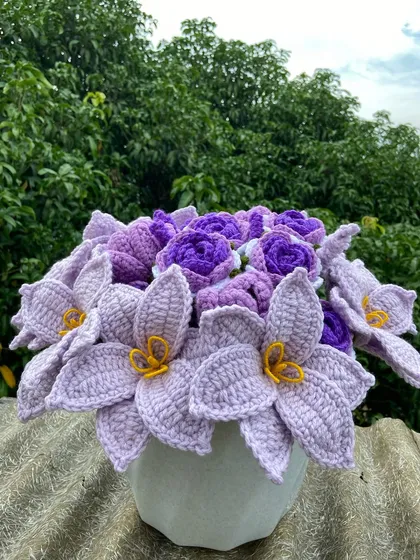The custom all-purple bouquet arranged in a vase, a beautiful centerpiece.