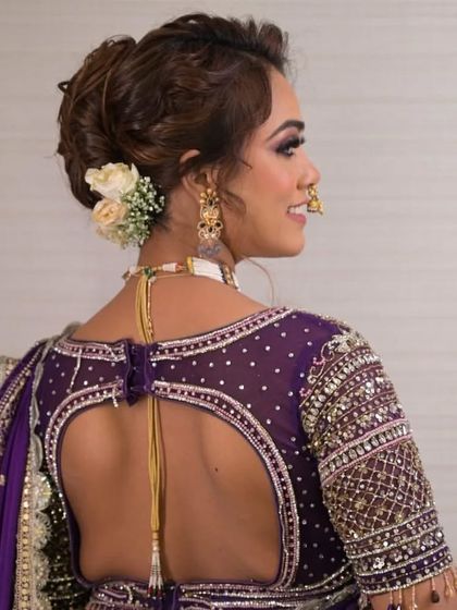 For this stunning Maharashtrian bridal look, I created a soft, textured updo. The side placement of fresh flowers adds a modern twist to the traditional hairstyle.