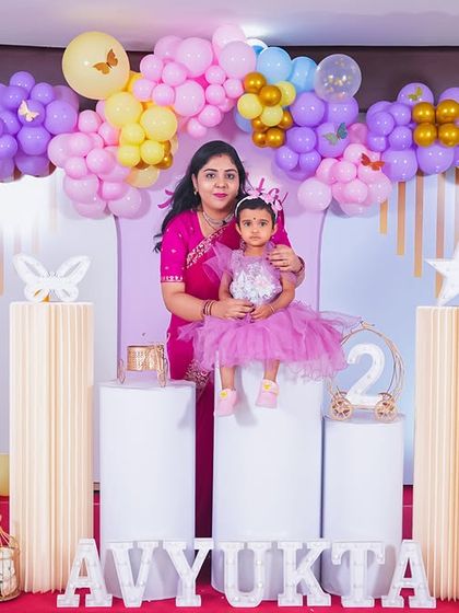 A playful 'Mickey Mouse' themed birthday party, with bright colors, character cutouts, and a fun balloon arch, creating a joyful atmosphere for little ones.