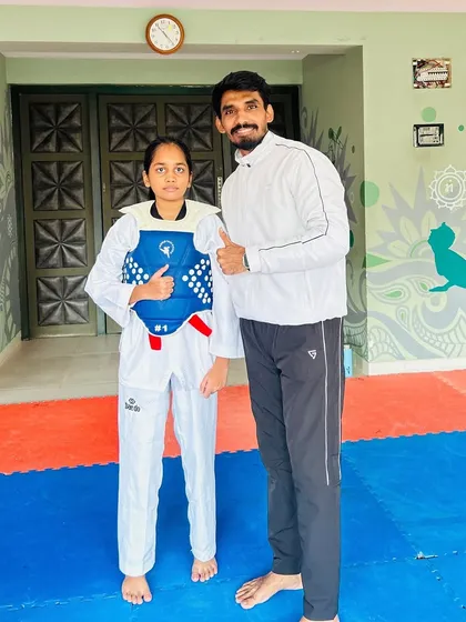 Posing with my student Swara Tarde after she won a silver medal. Her dedication during training is an inspiration to others.