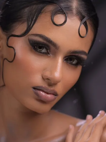 A powerful close-up of the sculpted wet-look hair and intense black graphic eyeliner. This level of detail is what sets a professional artist apart.