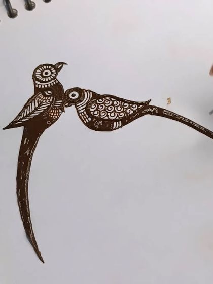 The completed outline for a pair of parrots. This is a classic romantic motif used in bridal mehndi.