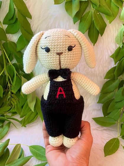 A dapper boy bunny! This little buck looks so smart in his black overalls with a personalized initial and a matching bow tie.