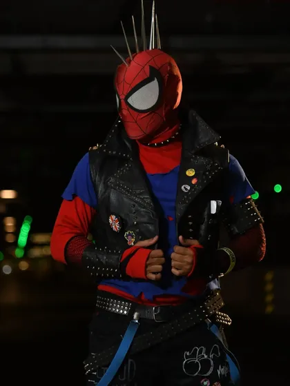 A close-up of the Spider-Punk cosplay, showing the details on the studded vest and mask.