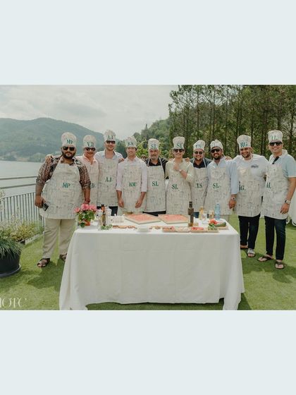 A group of guests proudly showing off their custom chef aprons at the DIY pizza party.