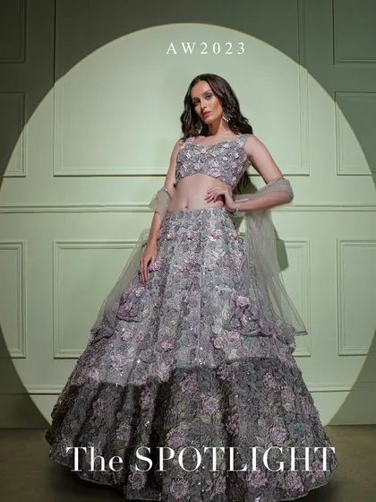 A campaign shot of the grey ombre floral lehenga from "The Spotlight" collection, capturing its dramatic and romantic feel.