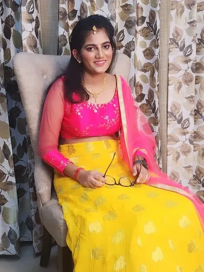 The daughter from the mother-daughter pair, with a fresh and youthful makeup look perfect for a family function.