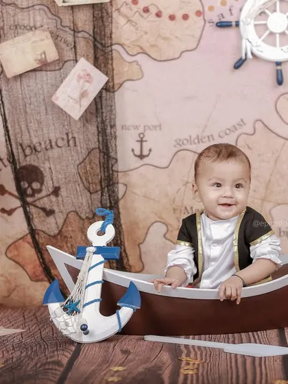 Ahoy, matey. This little sailor is ready for an adventure on the high seas in our pirate-themed boat prop, complete with a treasure map background.