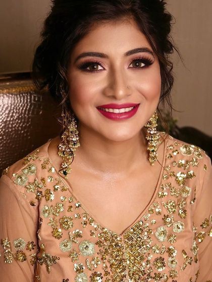 A stunning party look that’s all about radiance. Here you can see the beautifully blended eyeshadow, sharp liner, and a bold magenta lip that brings the whole look together.