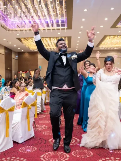 Jumping for joy! The couple's enthusiastic entrance sets the tone for a fun-filled reception party.