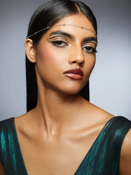 The full look, featuring a sharp graphic liner, a sleek hairstyle, and a delicate headpiece. This image is a perfect example of a polished, editorial portfolio piece.