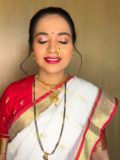 A detailed makeup shot. I used a rosy eyeshadow and a bold red lip to create a classic and celebratory feel, perfect for the white and red saree.