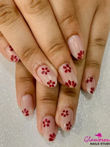 A simple yet charming design of delicate, hand-painted red flowers on a clean, nude base. This look is perfect for a touch of understated elegance.