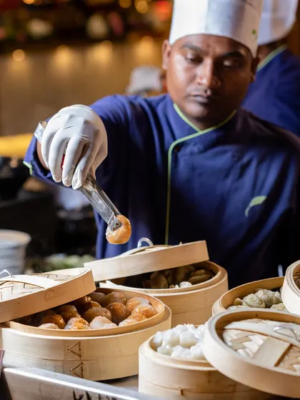 Our chefs bring global traditions to your plate. This live station features a chef expertly preparing a variety of vegetarian dim sum, served steaming hot from traditional bamboo baskets for an authentic Pan-Asian experience.