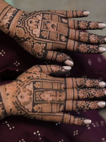 A close-up shot of a bride's hands, filled with intricate block-style patterns. This design is perfect for brides who love dense, traditional artwork.