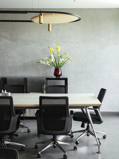 The conference room in our studio features polished concrete walls and a custom-designed light fixture. The space is designed to be a neutral, focused environment for client meetings and team discussions.