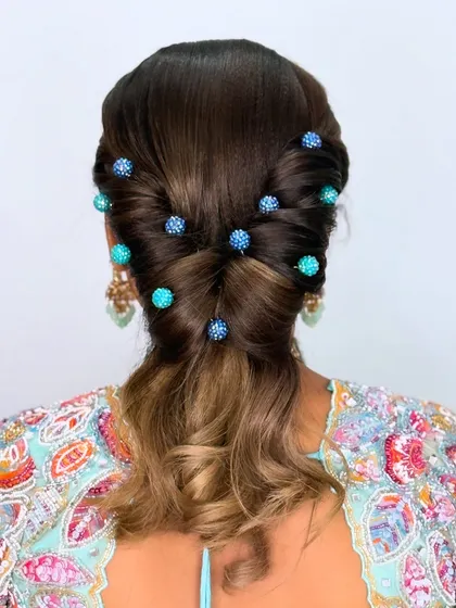 A modern hairstyle featuring custom-made blue beaded hairpins, adding a pop of color and sparkle to the look.