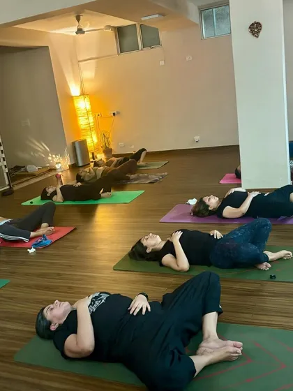 The end of a class, with students resting deeply in Savasana. This is a sacred time for integration and restoration.