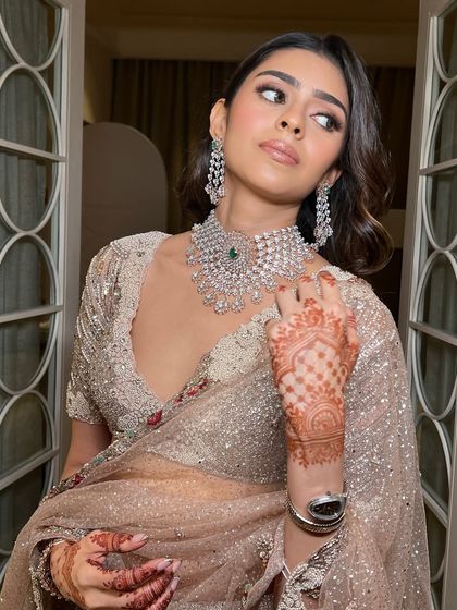 Rose gold dreams. This look is all about minimal yet impactful glamour, with a focus on shimmery eyeshadow and a flawless base that makes the skin look lit from within, perfectly complementing her sparkling Dolly J lehenga.