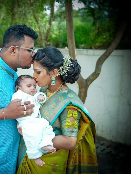 Kisses for the little one. This intimate moment between parents and their newborn is a perfect example of the candid, emotional photography I love.