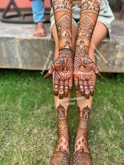 This outdoor shot showcases a full set of bridal mehandi on hands and feet, featuring traditional palace and elephant motifs.