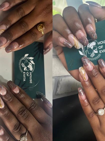 A beautiful example of marble and glitter nail art. This design combines a soft glitter gradient with a realistic marble effect on accent nails for a textured, luxurious finish.