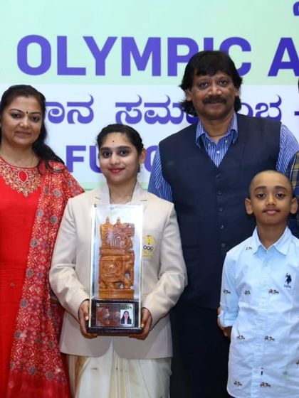 Ms. Yukthi Rajendra with her family and coaches after receiving the KOA award. This award recognizes her excellent performance in sports shooting, developed from the grassroots level at our hub.