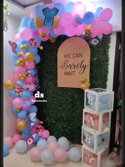 An alternate view of the "We Can Barely Wait" baby shower setup. This angle shows how the balloon arch frames the backdrop and props, creating a complete and immersive photo corner.