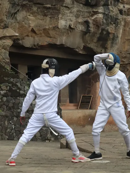 Two of our fencers in a heated practice match. The focus is on the precise blade work and footwork as they vie for the advantage.