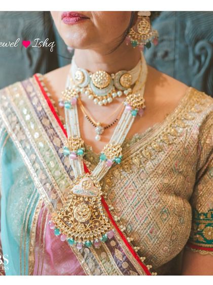 A real bride from Sydney wearing a custom-made pastel Polki choker and layered necklace that perfectly matches her multi-colored lehenga.