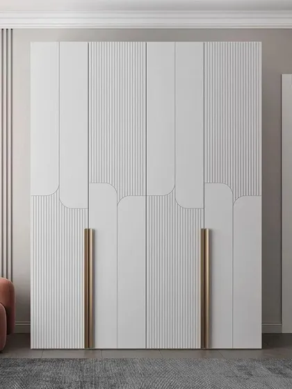 A stunning example of a modern wardrobe with curved and fluted details. The long, metallic handles add a touch of glamour to the clean white finish.