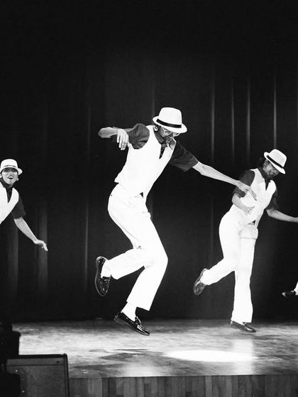 A black and white action shot from "The Pressure," capturing the dancers in mid-air.