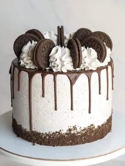 A classic Cookies & Cream birthday cake. This cake is frosted with Oreo-infused cream, features a chocolate drip, and is generously topped with whole Oreo cookies.