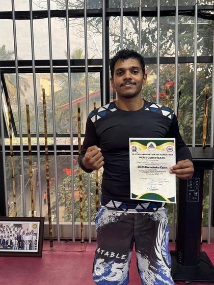 Holding my merit certificate after winning Gold at the 2024 Karnataka Open. It’s always a great feeling to represent my team and bring home a win.