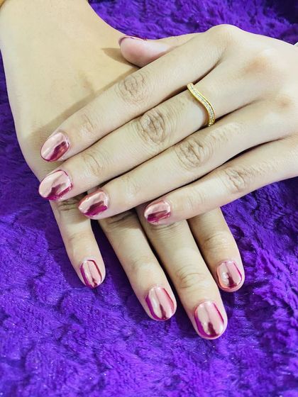 A beautiful set of short nails with a pink and red chrome finish.