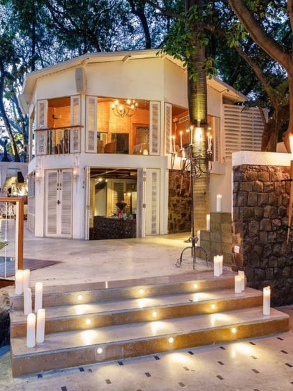 The entrance to the terrace, lit by candles, welcoming guests into a Spanish-inspired oasis in the heart of Delhi.