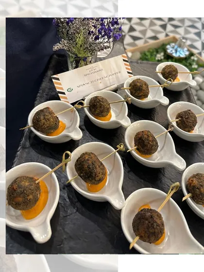 Spoonfuls of deliciousness. These savory bites are served on individual ceramic spoons with a dollop of flavorful sauce, making for an elegant and easy to eat appetizer.